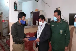 تجلیل از خانواده شهید پودینه در هیرمند