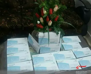 ذبح گوسفند و توزیع بن خرید کالا در میان نیازمندان